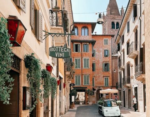 Idyllic street scene in Verona, Italy, featuring historic architecture and a vibrant atmosphere.