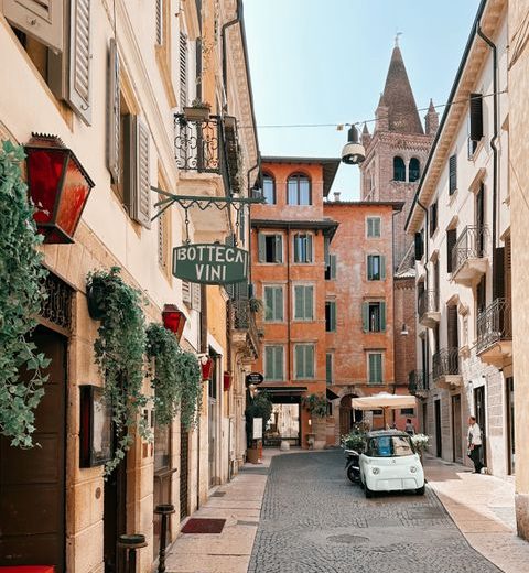 Idyllic street scene in Verona, Italy, featuring historic architecture and a vibrant atmosphere.